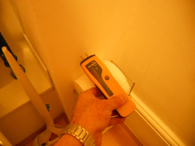 Rising Damp walls in house shown on a moisture meter used by a chartered surveyor